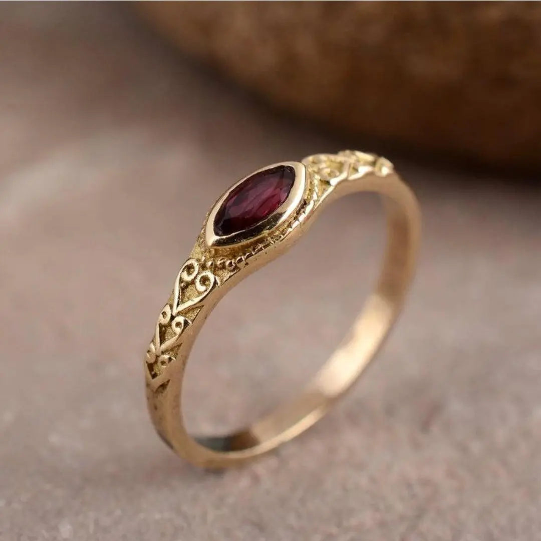 Antique gold ring with red crystal